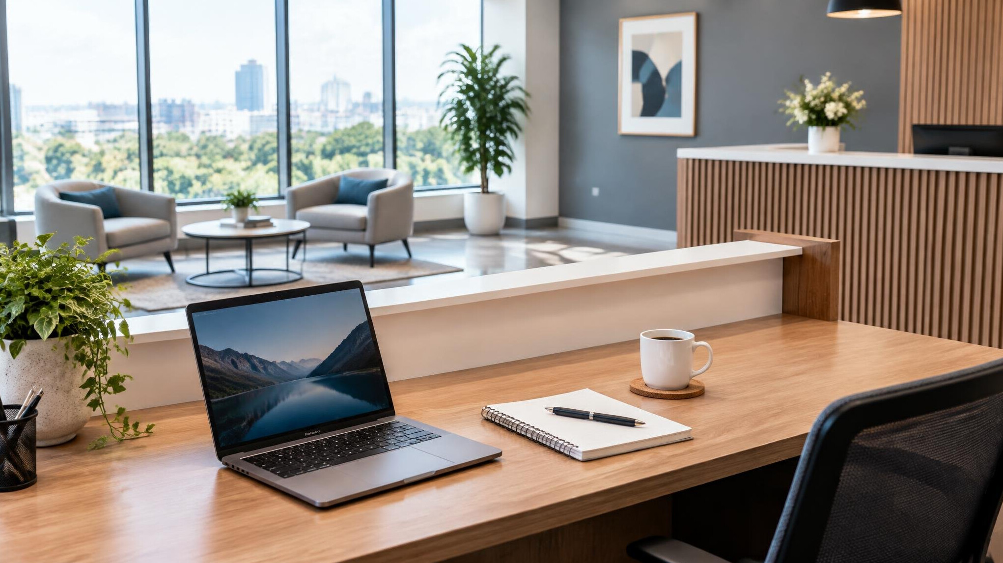 Office reception desk with a laptop and notebook