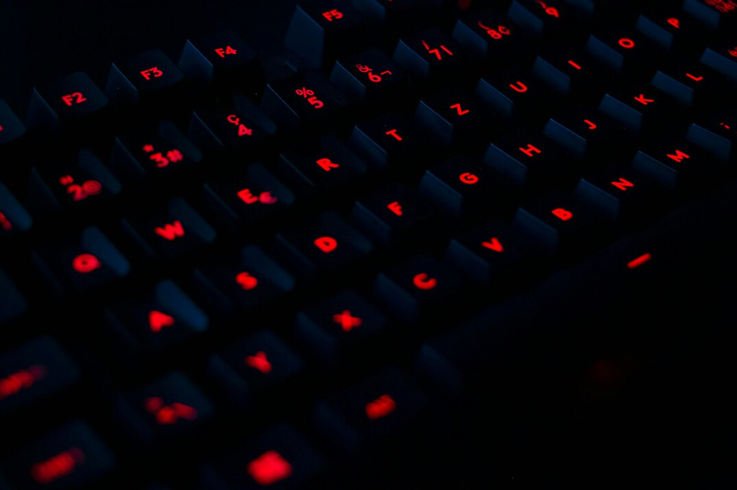 Close-up of hands typing code on a laptop keyboard